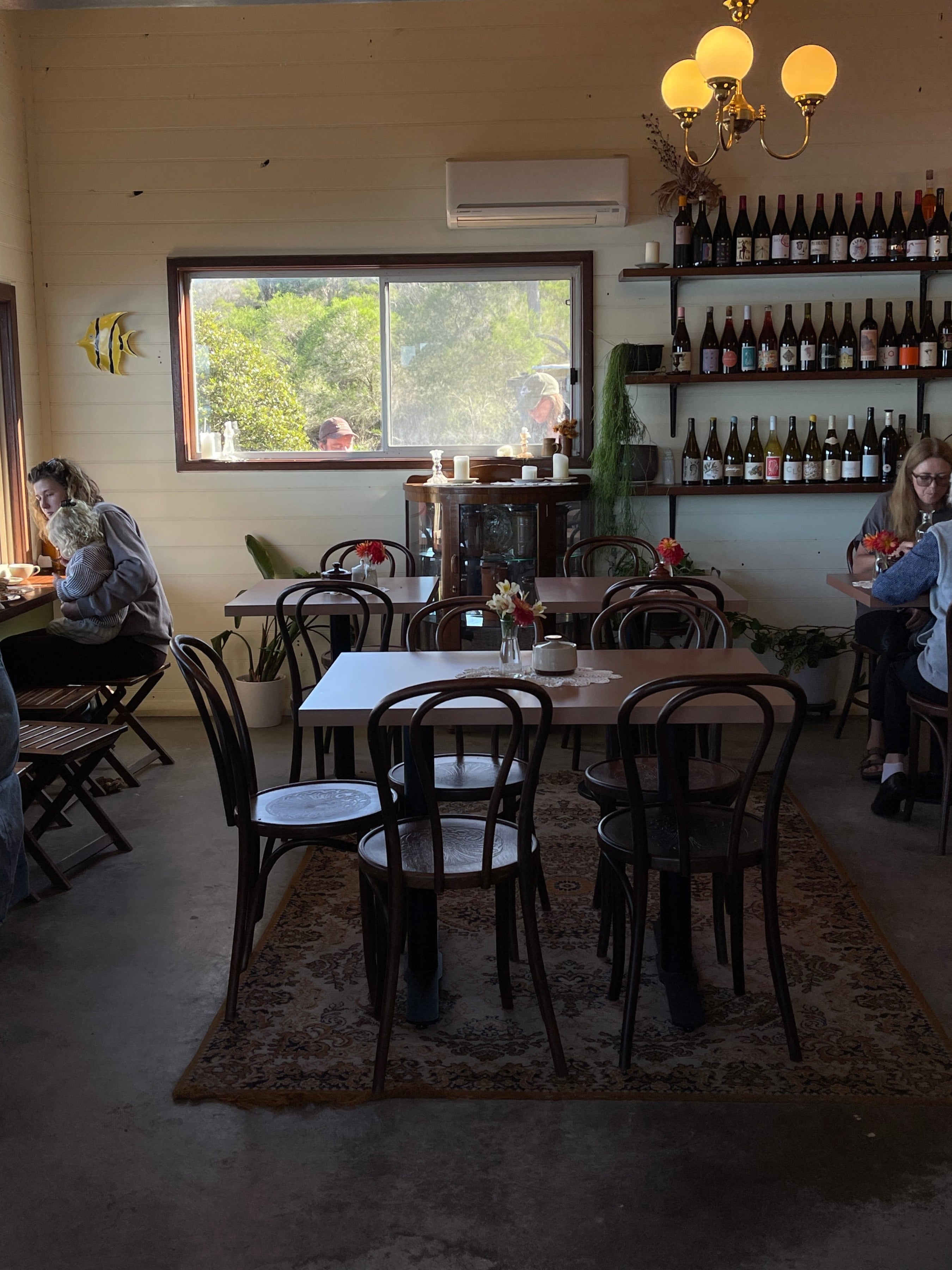 Cafe Dining room with a large window reflecting part of the room.
